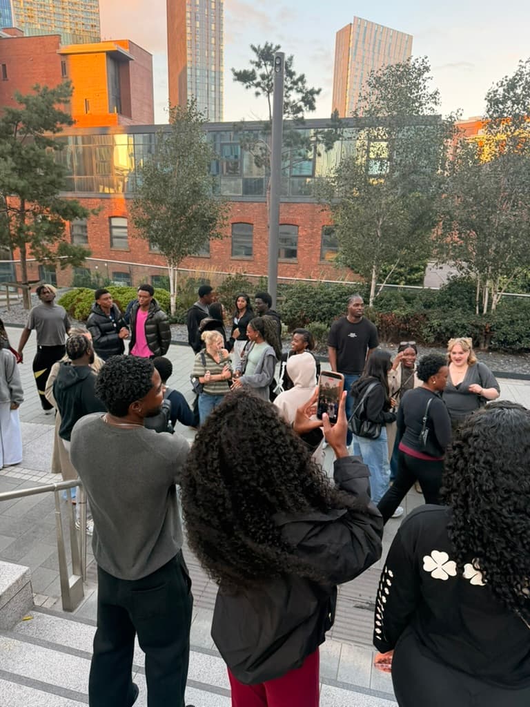Walking in Faith community members chatting together on outdoor steps in Manchester